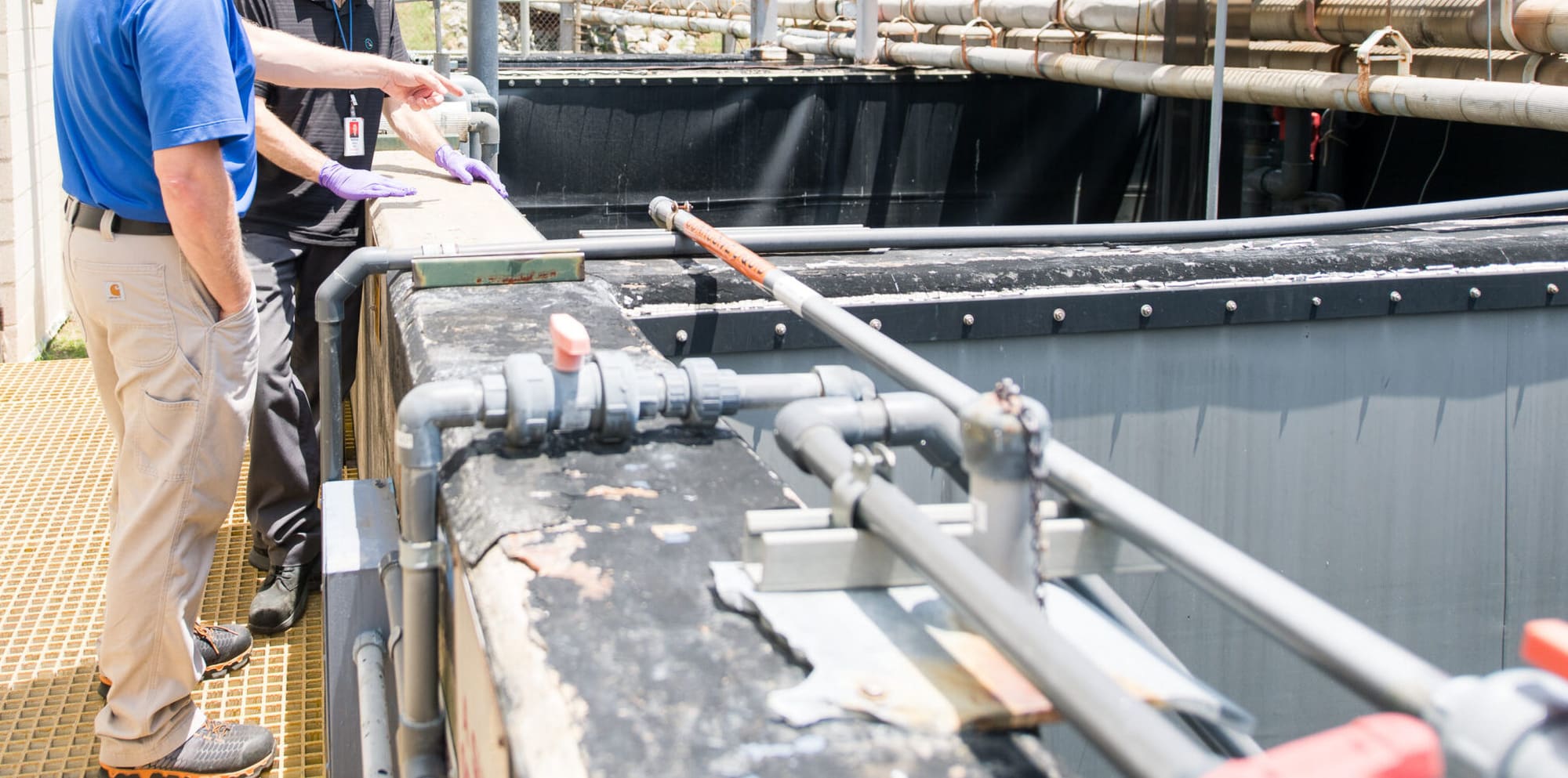 Operators Unlimited technician working with wastewater treatment chemicals